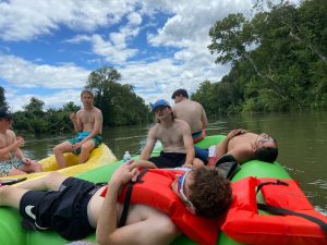 Float trip with brothers relaxing on rafts